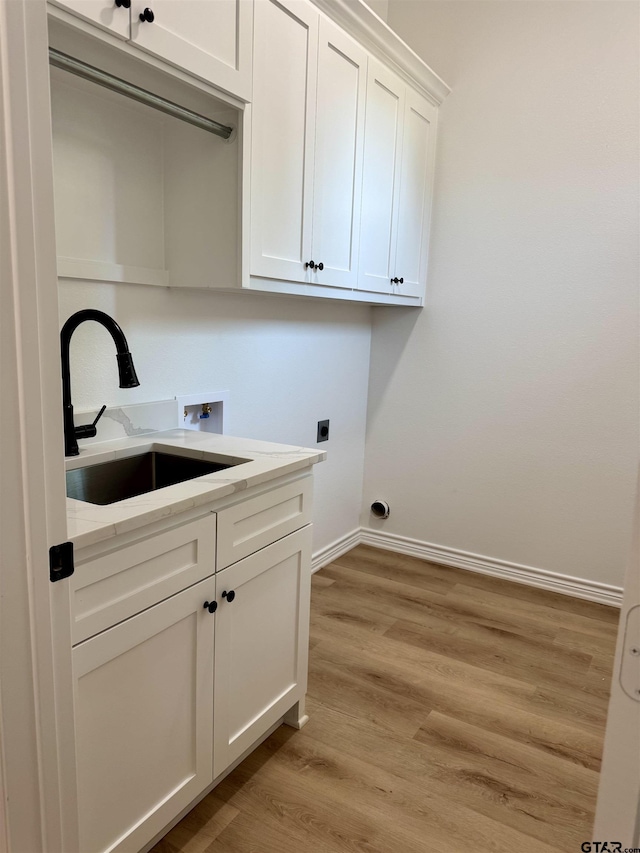 15939 Shepards Gln, Lindale, TX 75771 - laundry room featuring hookup for a washing machine, electric dryer hookup, cabinet space, and light wood finished floors
