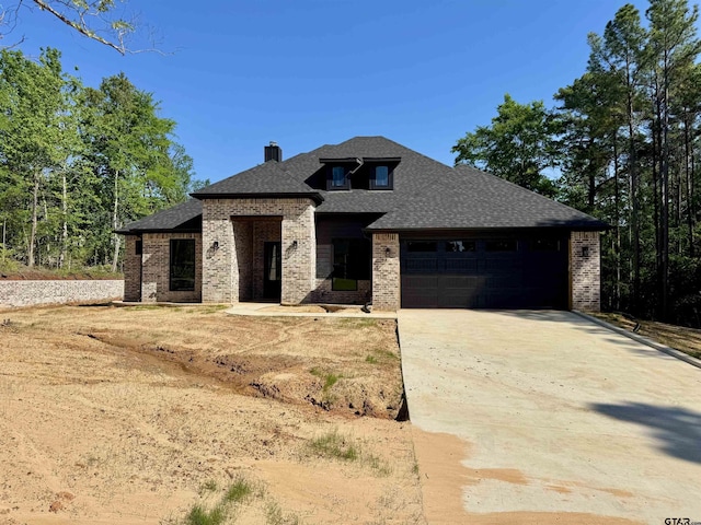 15939 Shepards Gln, Lindale, TX 75771 - view of front of house with brick siding, an attached garage, and concrete driveway