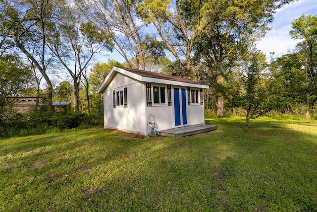 view of outdoor structure featuring a lawn