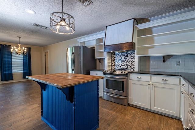 kitchen with white cabinetry, appliances with stainless steel finishes, backsplash, dark hardwood / wood-style flooring, and hanging light fixtures