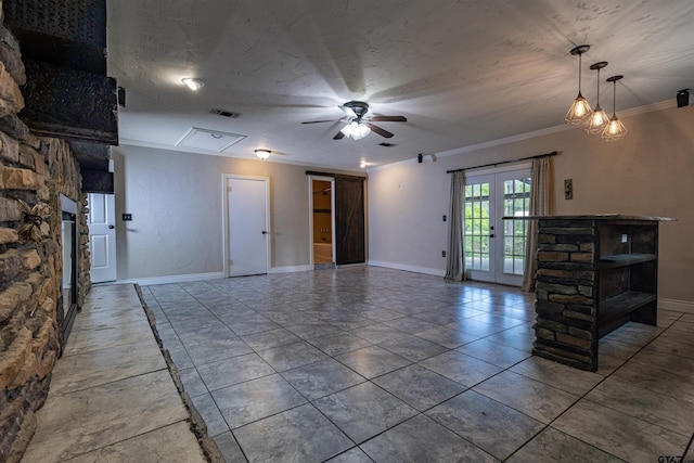 unfurnished living room featuring ornamental molding, french doors, a textured ceiling, and ceiling fan