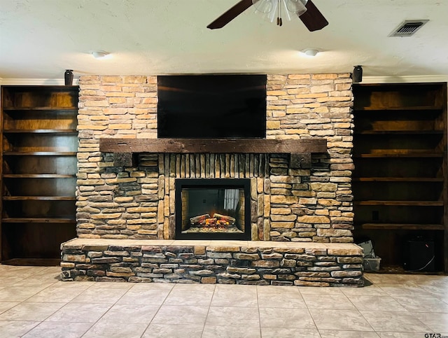 unfurnished living room featuring ceiling fan, a stone fireplace, and tile patterned floors