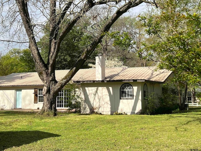 rear view of property featuring a yard