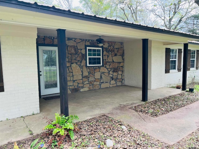 view of exterior entry featuring ceiling fan