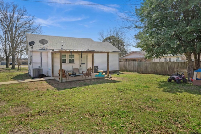 rear view of property featuring a yard, a patio, cooling unit, and fence