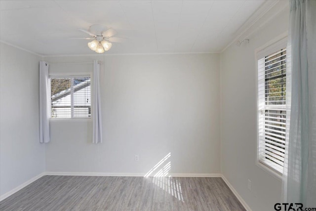 empty room with hardwood / wood-style floors, ceiling fan, and ornamental molding