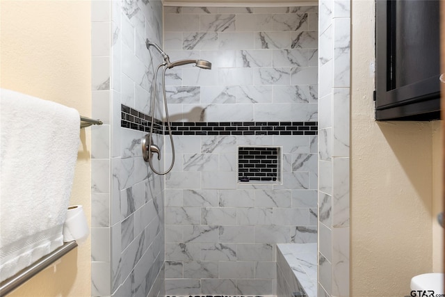 bathroom with tiled shower