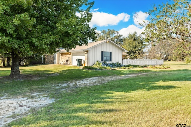 view of property exterior featuring a yard and a garage