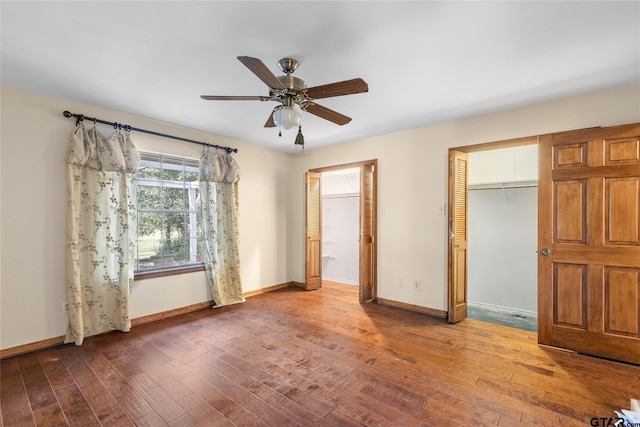 unfurnished bedroom with ceiling fan and hardwood / wood-style flooring