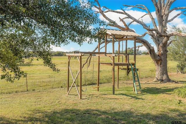 view of play area with a rural view and a lawn