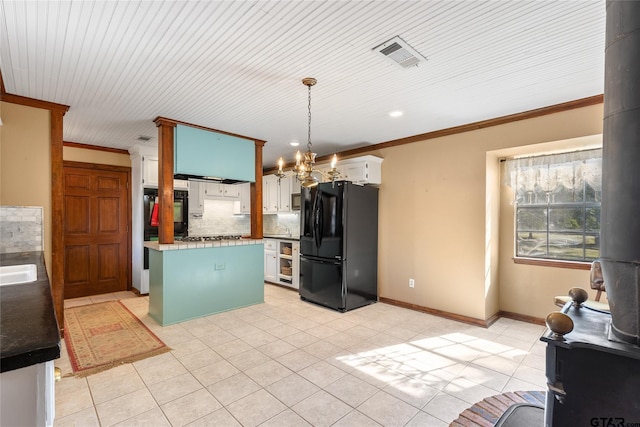 kitchen featuring white cabinetry, black appliances, pendant lighting, crown molding, and a center island