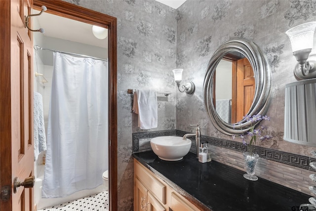 bathroom featuring shower / bath combo, tasteful backsplash, and vanity