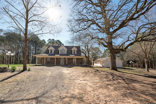 view of front of home with brick siding and driveway