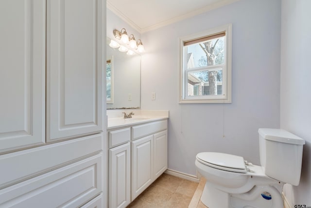 bathroom with vanity, baseboards, ornamental molding, tile patterned floors, and toilet