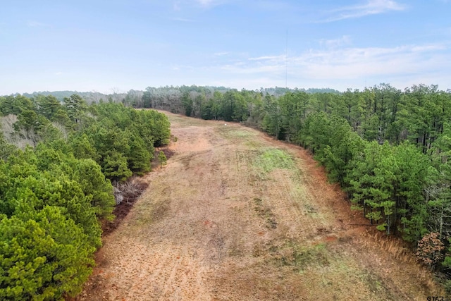 bird's eye view featuring a wooded view