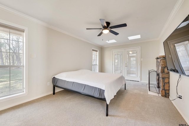 bedroom featuring french doors, light carpet, baseboards, and ornamental molding