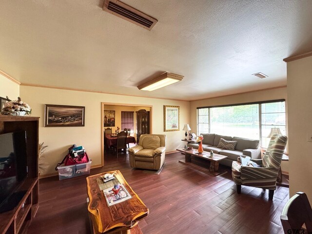 1207 E Redbud Ave, Crockett, TX 75835 - living room featuring a textured ceiling, visible vents, and wood finished floors