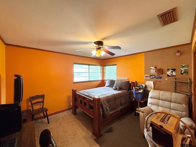 1207 E Redbud Ave, Crockett, TX 75835 - bedroom with crown molding, a ceiling fan, light wood finished floors, baseboards, and visible vents