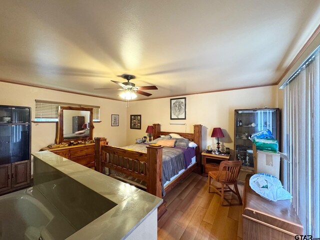 1207 E Redbud Ave, Crockett, TX 75835 - bedroom with crown molding, wood finished floors, and ceiling fan