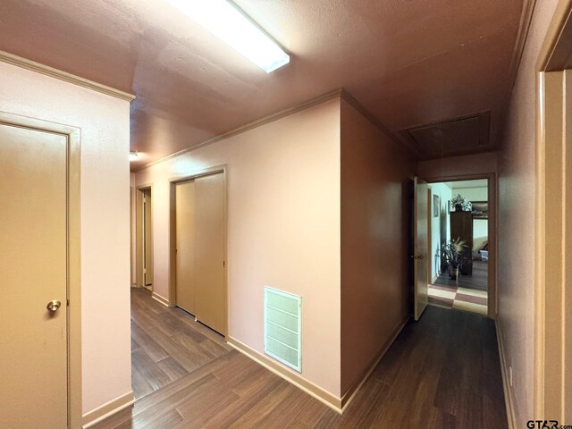 1207 E Redbud Ave, Crockett, TX 75835 - hall featuring crown molding, visible vents, attic access, and wood finished floors