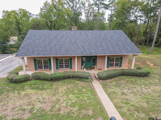 view of front of property featuring covered porch and a front yard