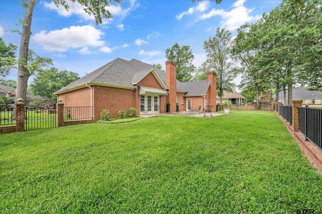 2003 Royal Oak Dr, Tyler, TX 75703 - rear view of property with french doors, brick siding, a patio area, a chimney, and a shingled roof
