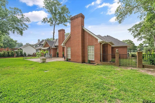 2003 Royal Oak Dr, Tyler, TX 75703 - rear view of house featuring a patio, brick siding, and a chimney