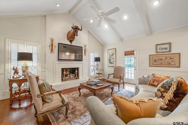 2003 Royal Oak Dr, Tyler, TX 75703 - living room featuring wood finished floors, ceiling fan, beam ceiling, a fireplace, and high vaulted ceiling