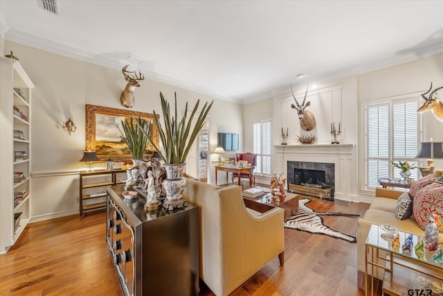 2003 Royal Oak Dr, Tyler, TX 75703 - living room featuring light wood finished floors, a fireplace, crown molding, and baseboards
