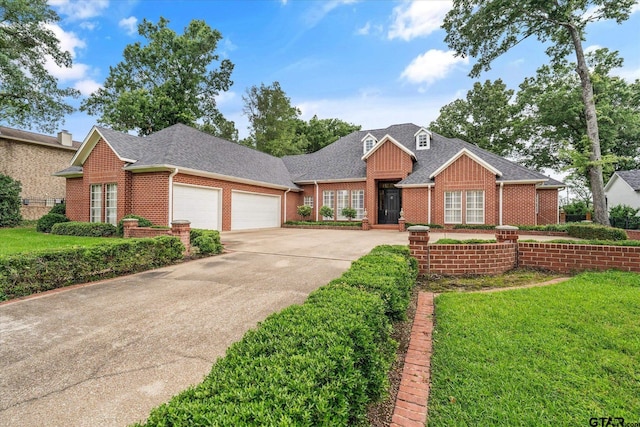 2003 Royal Oak Dr, Tyler, TX 75703 - view of front of property with a garage, brick siding, concrete driveway, roof with shingles, and a front lawn
