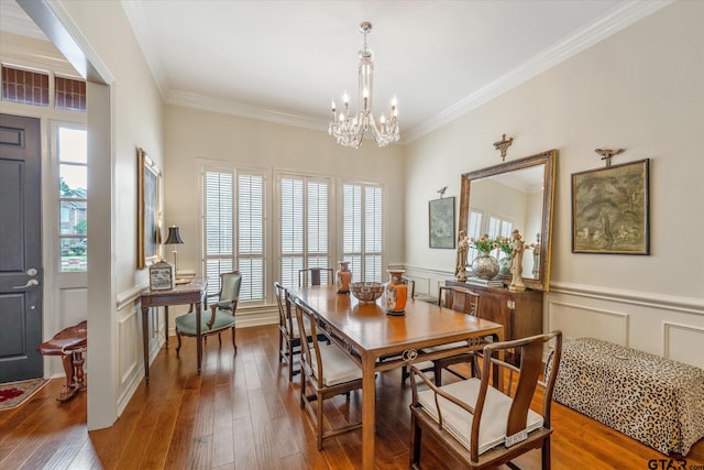 2003 Royal Oak Dr, Tyler, TX 75703 - dining space with a chandelier, ornamental molding, hardwood / wood-style flooring, a decorative wall, and a wainscoted wall