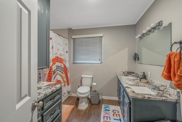 bathroom featuring hardwood / wood-style flooring, vanity, toilet, and ornamental molding