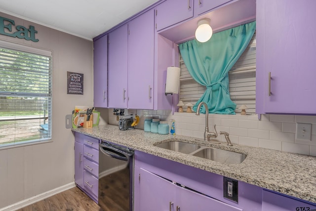 kitchen with wood-type flooring, light stone counters, dishwasher, sink, and ornamental molding