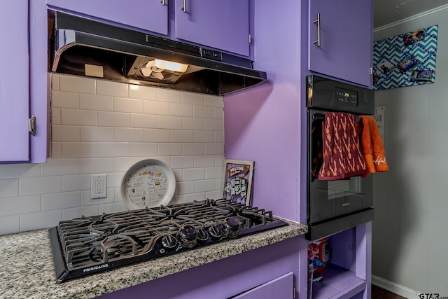 kitchen featuring light stone counters, black appliances, decorative backsplash, and blue cabinets