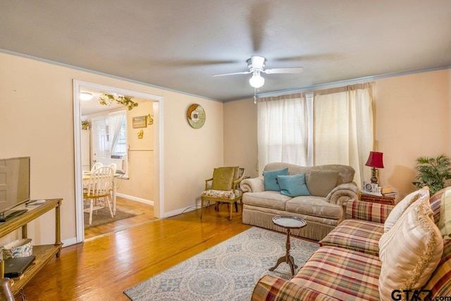 2200 N Horn Ave, Tyler, TX 75702 - living room with a ceiling fan, wood finished floors, baseboards, and ornamental molding