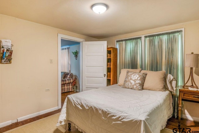 2200 N Horn Ave, Tyler, TX 75702 - bedroom with baseboards, wood finished floors, crown molding, and a closet