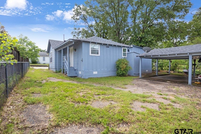 2200 N Horn Ave, Tyler, TX 75702 - back of property featuring entry steps, board and batten siding, crawl space, and roof with shingles