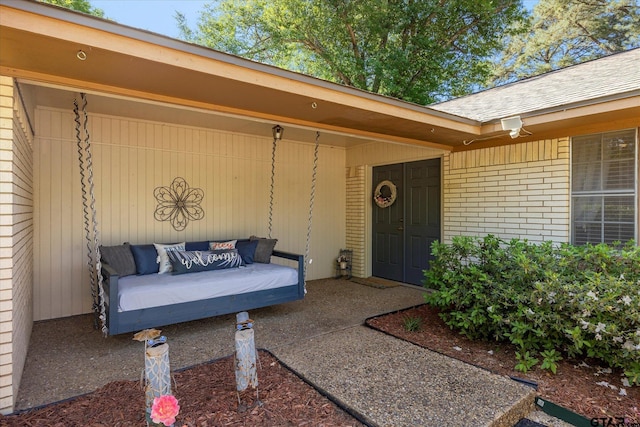 223 Guadalupe Dr, Athens, TX 75751 - view of exterior entry with brick siding, a shingled roof, and outdoor lounge area