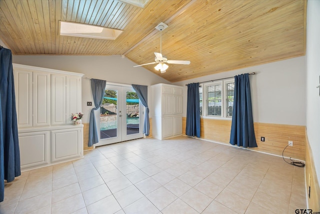 223 Guadalupe Dr, Athens, TX 75751 - unfurnished room featuring wood ceiling, vaulted ceiling, french doors, a skylight, and light tile patterned flooring