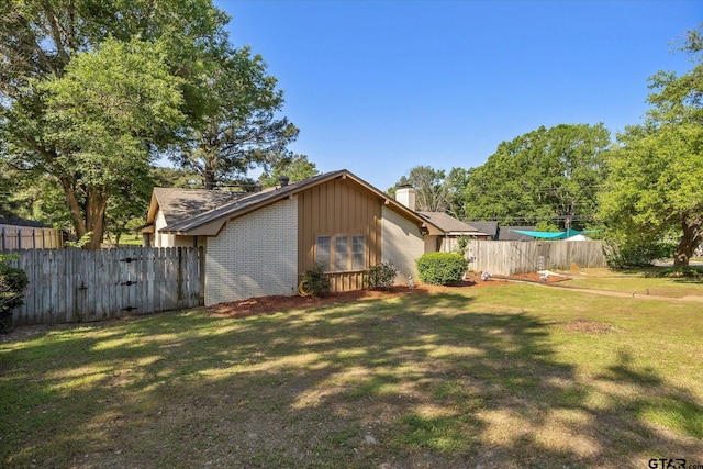 223 Guadalupe Dr, Athens, TX 75751 - view of side of property with brick siding, a chimney, and board and batten siding