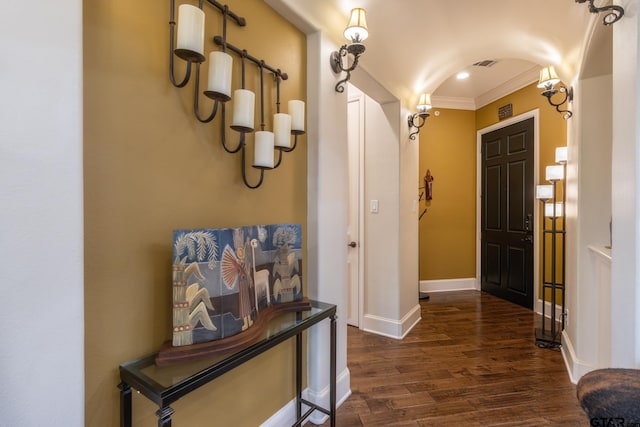 hallway with dark wood-type flooring and crown molding