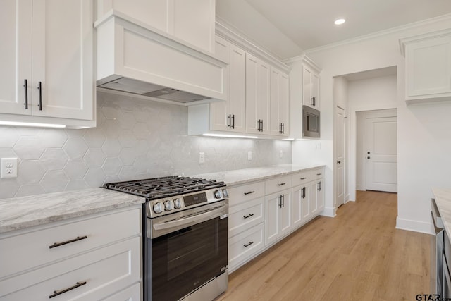 kitchen featuring white cabinetry, light stone countertops, light wood finished floors, gas stove, and custom range hood