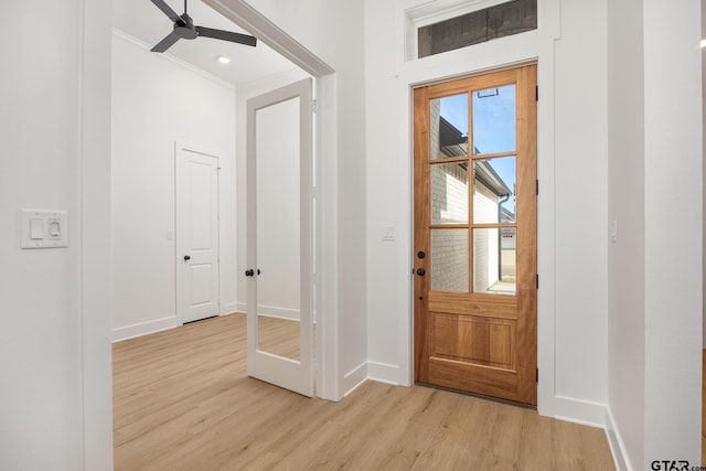 entrance foyer featuring ceiling fan, light wood finished floors, and baseboards