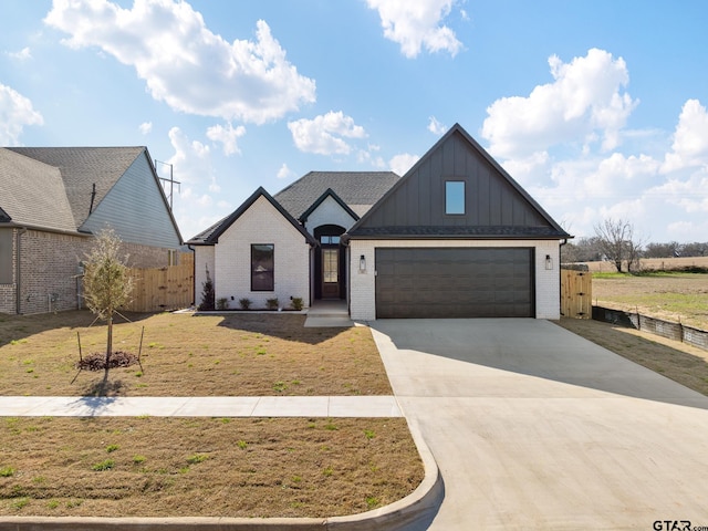 view of front of property featuring brick siding, a front lawn, board and batten siding, and concrete driveway