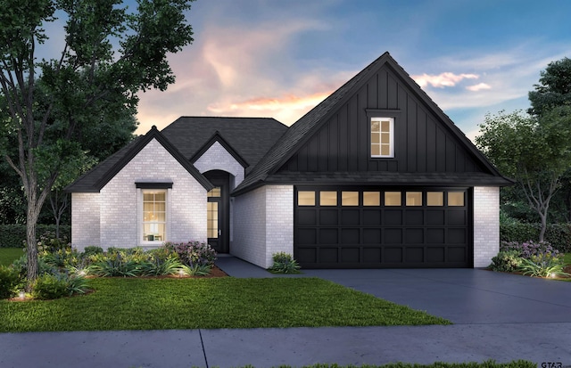 view of front facade with a lawn and a garage