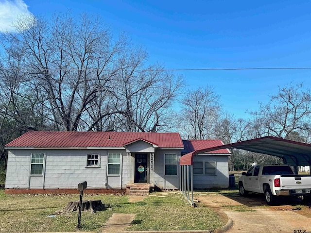 ranch-style home with a front lawn and a carport