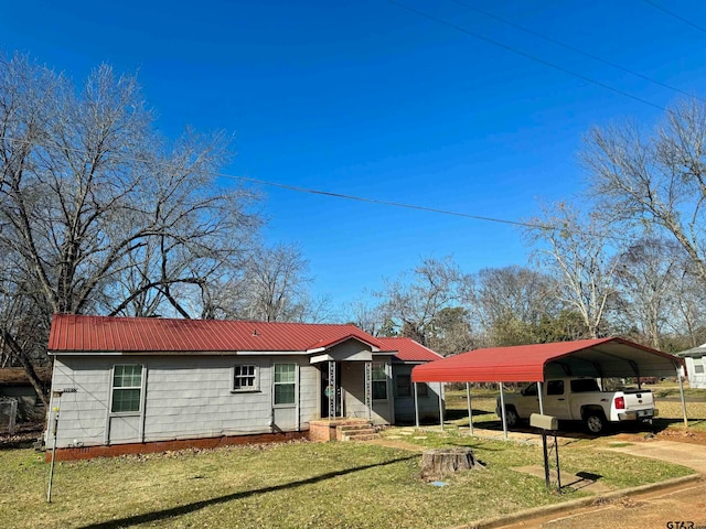 single story home with a front lawn and a carport