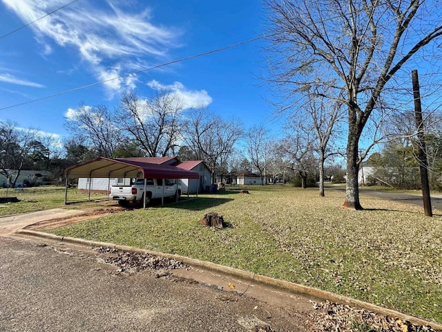 view of front of house with a front lawn and a carport