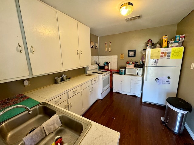 kitchen featuring white cabinets, white appliances, dark hardwood / wood-style floors, and sink