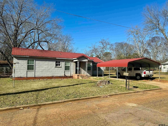 ranch-style home featuring a front yard and a carport